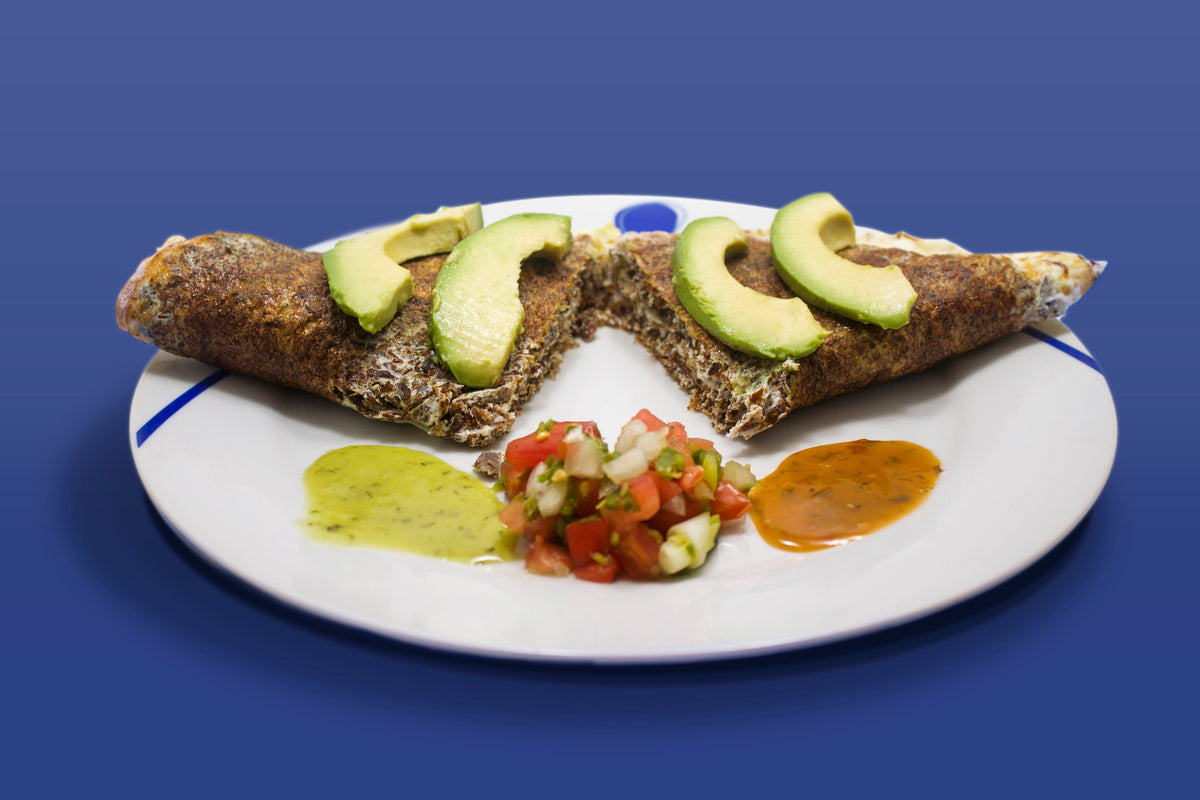 Egg-white Machacado omelette served with avocado slices, salsa and vegetables